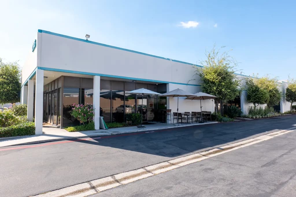 The Green Olive storefront with patio umbrellas